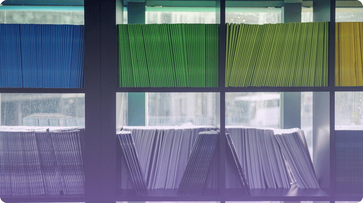 Bookshelf in front of a window with colored folders