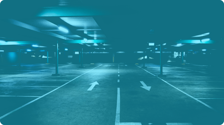 parking garage with arrows at night