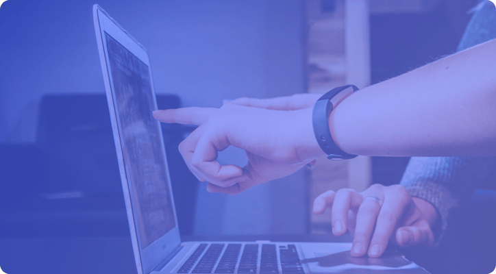 hands pointing at a computer laptop screen